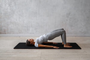Woman_Practicing_Yoga_Bridge_Pose
