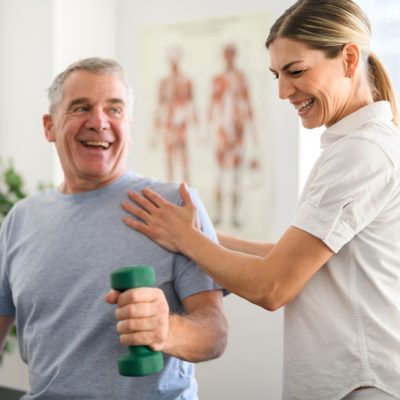 Physiotherapist_Doing_Shoulder_Assessment_And_Exercises_With_Senior_Client